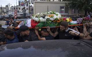 Palestinian mourners carry the body of Shireen Abu Akleh out of the office of Al Jazeera after friends and colleagues paid their respects, in the West Bank city of Ramallah, Wednesday, May 11, 2022
