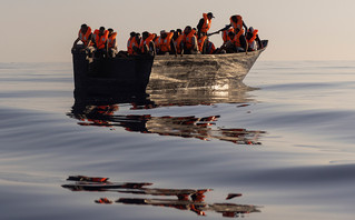 Migrants with life jackets in a boat Migrants with life jackets in a boat