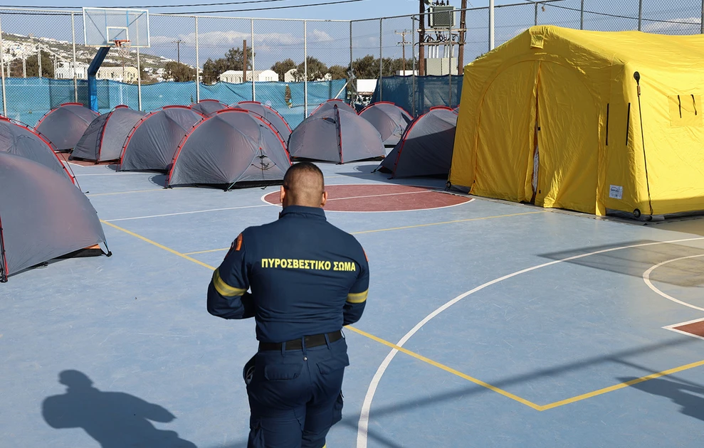 a man standing in front of tents