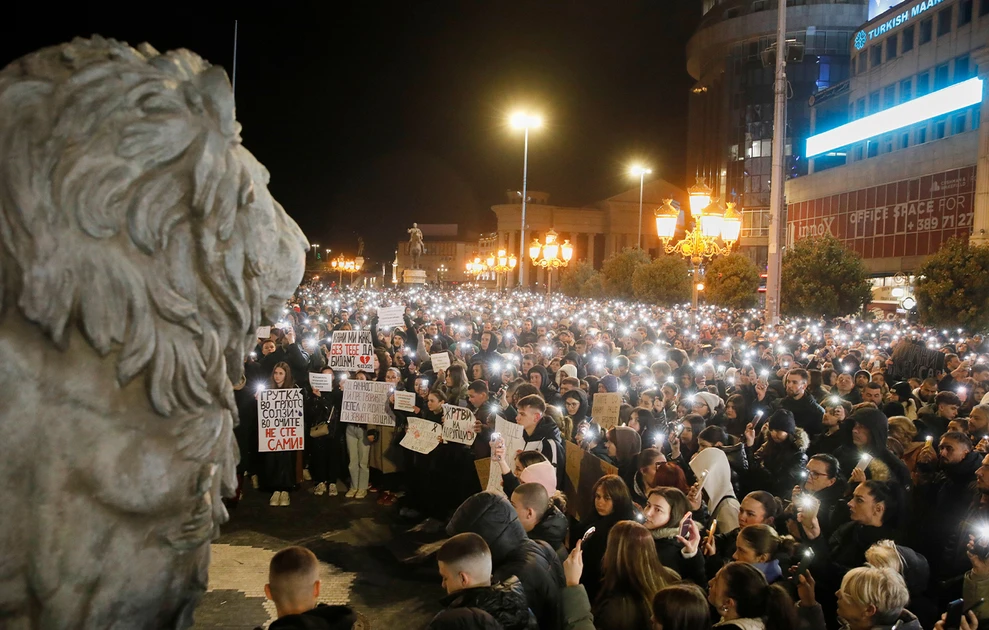 a group of people holding signs and standing in a crowd