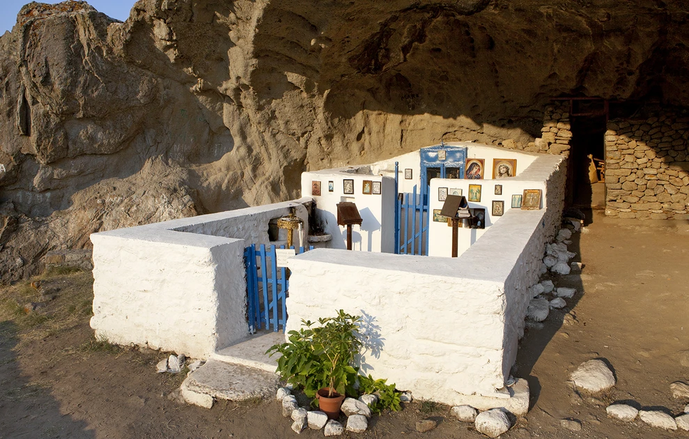 a white building with a blue gate and a blue gate