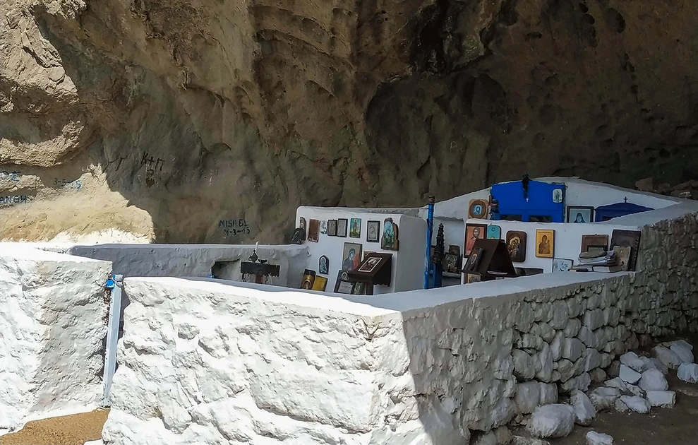 a white stone wall with pictures on it