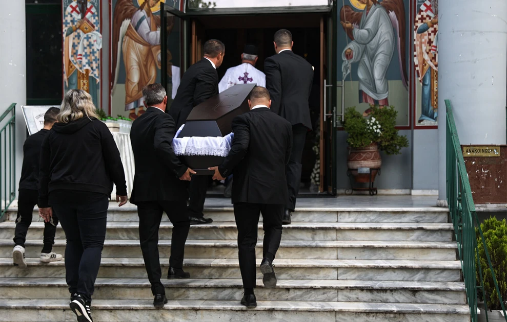 a group of people carrying a coffin