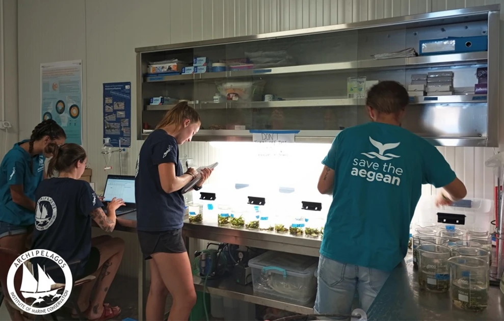 a group of people standing in a room with a light